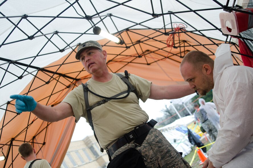 Lt. Col. Chet Kozak, a physician assistant with the 139th Medical Group, assists a role-player posing as a victim during a Region 7 Homeland Response Force exercise at Muscatatuck Urban Training Center near Butlerville, Ind., March 23, 2012. More than 500 Missouri National Guard soldiers and airmen participated in the exercise, which evaluates their ability to react to large-scale disasters within the U.S. (Missouri Guard photo by Staff Sgt. Michael Crane)