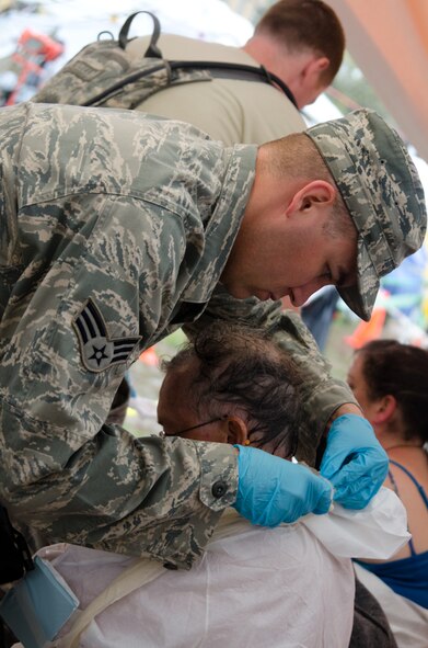 Senior Airman Daniel Wynkoop, an aerospace medical technician with the 139th Medical Group, assists a mock patient during a Region 7 Homeland Response Force exercise at Muscatatuck Urban Training Center near Butlerville, Ind., March 23, 2012. More than 500 Missouri National Guard soldiers and airmen participated in the exercise, which evaluates their ability to react to large-scale disasters within the U.S. (Missouri Guard photo by Staff Sgt. Michael Crane)