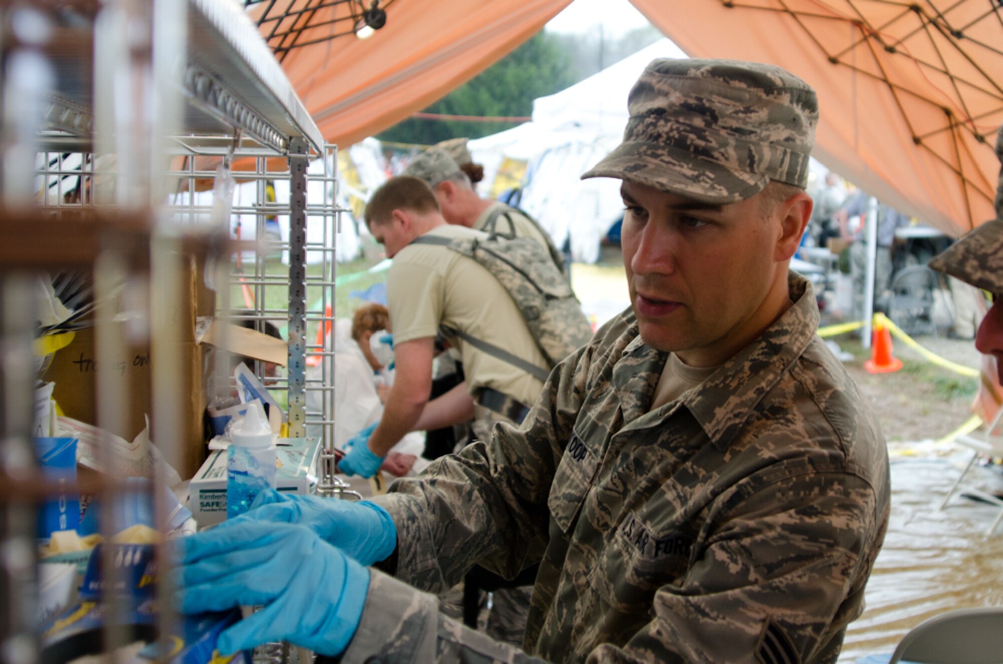Senior Airman Daniel Wynkoop, an aerospace medical technician with the 139th Medical Group, reaches for medical supplies during a Region 7 Homeland Response Force exercise at Muscatatuck Urban Training Center near Butlerville, Ind., March 23, 2012. More than 500 Missouri National Guard soldiers and airmen participated in the exercise, which evaluates their ability to react to large-scale disasters within the U.S. (Missouri Guard photo by Staff Sgt. Michael Crane)