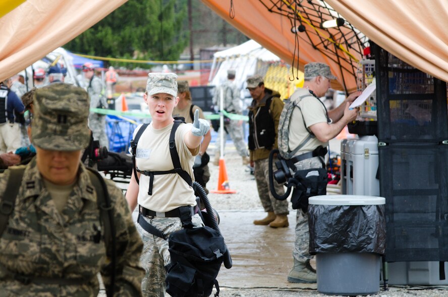 Senior Airman Elizabeth Seiter, an aerospace medical technician with the 139th Medical Group, informs the group that a mock patient has come through the medical tent during a Region 7 Homeland Response Force exercise at Muscatatuck Urban Training Center near Butlerville, Ind., March 23, 2012. More than 500 Missouri National Guard soldiers and airmen participated in the exercise, which evaluates their ability to react to large-scale disasters within the U.S. (Missouri Guard photo by Staff Sgt. Michael Crane)