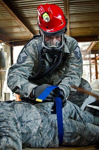 Master Sgt. George Corless, an aerospace medical technician with the 139th Medical Group, fastens a strap to a role-player posing as a victim during a Region 7 Homeland Response Force exercise at Muscatatuck Urban Training Center near Butlerville, Ind., March 20, 2012. More than 500 Missouri National Guard soldiers and airmen participated in the exercise, which evaluates their ability to react to large-scale disasters within the U.S. (Missouri Guard photo by Staff Sgt. Michael Crane)