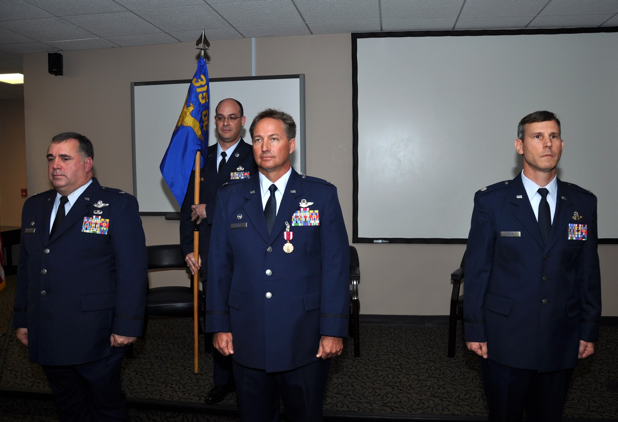 Col. Terry Lawrence, (far left) 315th Operations Group commander, presides over the change of command ceremony for the 315th Operations Support Squadron.  The squadron changed hands from Lt. Col. Eric Fornell (center) to Lt. Col. Stan Davis.  (U.S. Air Force Photo/Tech. Sgt. Scott Mathews)