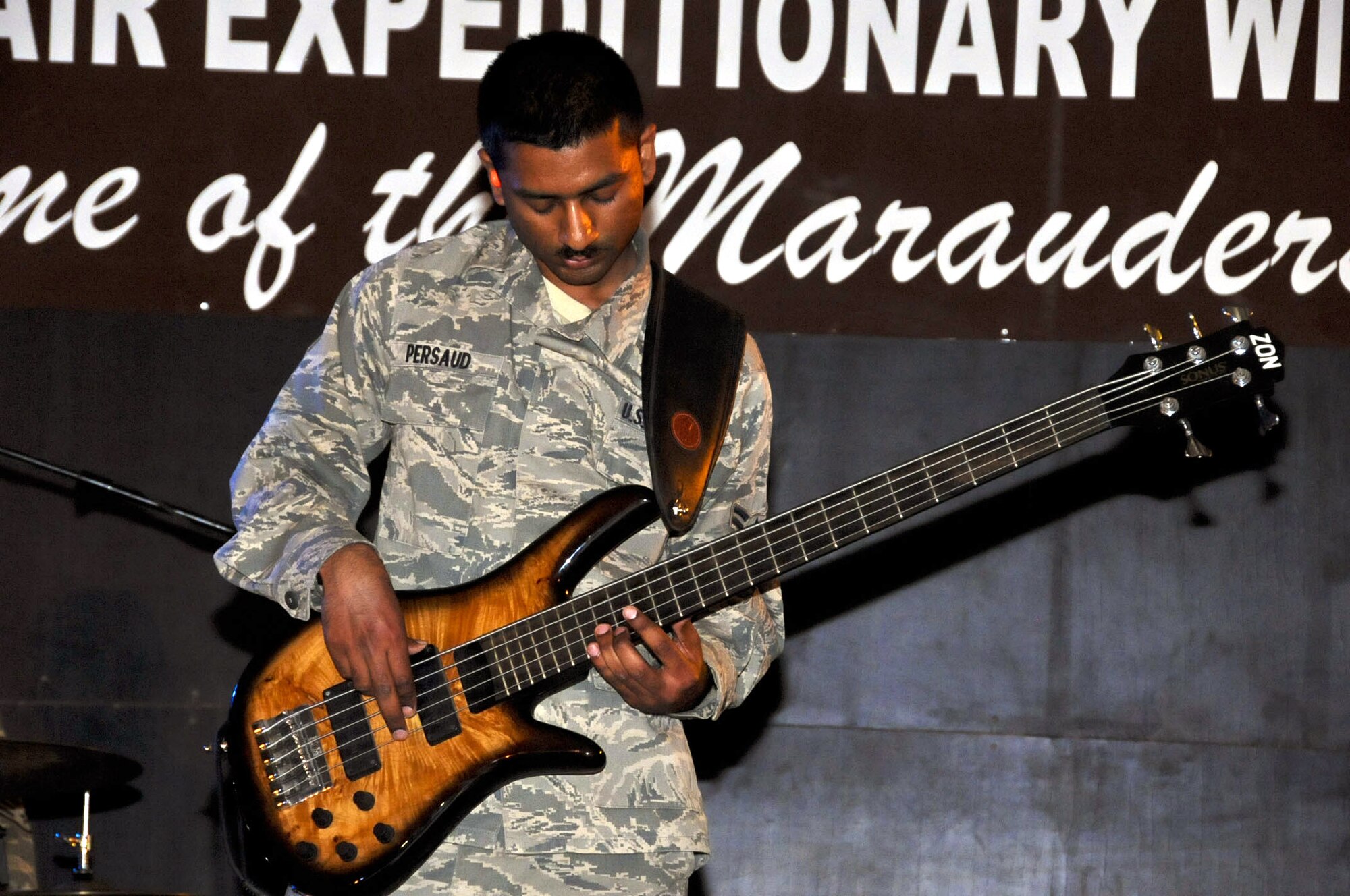 perform as part of the U.S. Air Forces Central Band, Night Wing, in an undisclosed location, Southwest Asia, Mar. 21, 2012.  The band, deployed from Offutt Air Force Base, Neb., is a country and rock music ensemble visiting countries around the U.S. Central Command area of responsibility, bringing an eclectic mix of new and classic tunes to the delight of host nation civilians and military members. (U.S. Air Force photo/Staff Sgt. James Lieth)