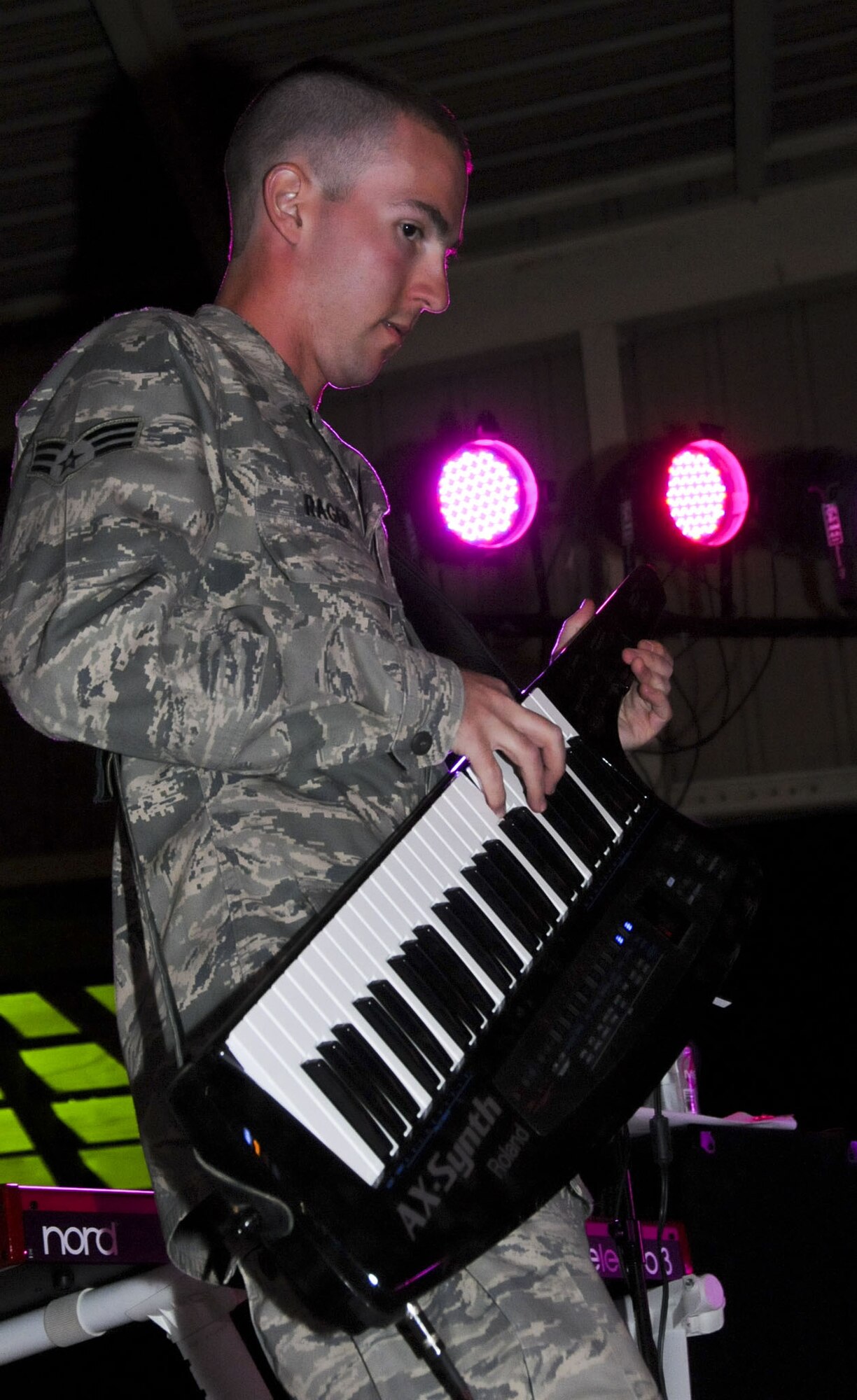 U.S. Air Force Senior Airman Ryan Rager, pianist, performs on his "keytar" as part of the U.S. Air Forces Central Band, Night Wing, in an undisclosed location, Southwest Asia, Mar. 24, 2012.  The band, deployed from Offutt Air Force Base, Neb., is a country and rock music ensemble visiting countries around the U.S. Central Command area of responsibility, bringing an eclectic mix of new and classic tunes to the delight of host nation civilians and military members. (U.S. Air Force photo/Staff Sgt. James Lieth)