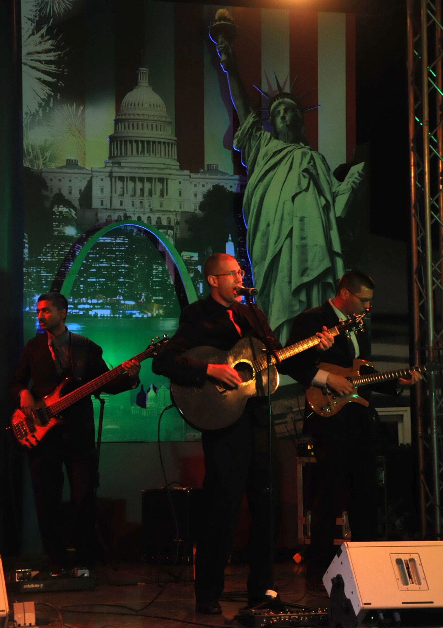(Left to right) U.S. Air Force Airman 1st Class Ryan Persaud, bass player, Airman 1st Class Lee Heerspink, male vocalist, and Master Sgt. Richard Baisden, lead guitarist, perform as part of the U.S. Air Forces Central Band, Night Wing, in an undisclosed location, Southwest Asia, Mar. 21, 2012.  The band, deployed from Offutt Air Force Base, Neb., is a country and rock music ensemble visiting countries around the U.S. Central Command area of responsibility, bringing an eclectic mix of new and classic tunes to the delight of host nation civilians and military members. (U.S. Air Force photo/Staff Sgt. James Lieth)