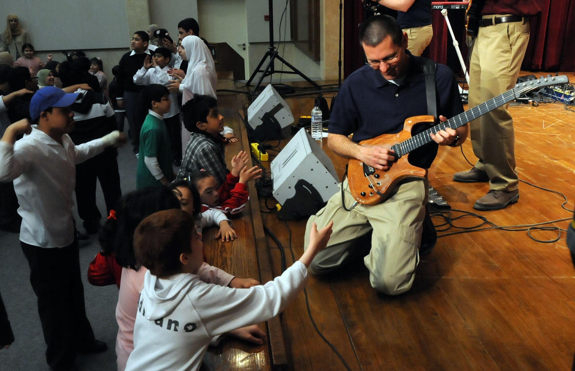U.S. Air Force Master Sgt. Richard Baisden, lead guitarist in the U.S. Air Forces Central Band, Night Wing, performs for children at a host nation hospital in an undisclosed location, Southwest Asia, Mar. 21, 2012.  The band, deployed from Offutt Air Force Base, Neb., is a country and rock music ensemble visiting countries around the U.S. Central Command area of responsibility, bringing an eclectic mix of new and classic tunes to the delight of host nation civilians and military members. (U.S. Air Force photo/Staff Sgt. James Lieth)