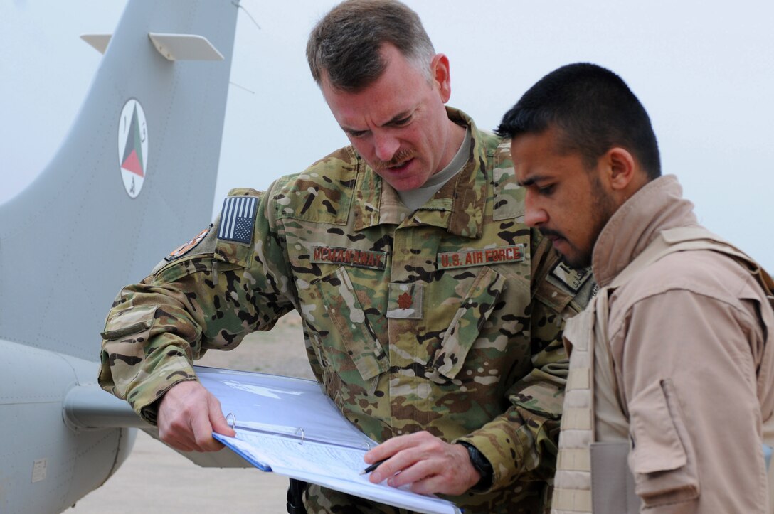 Maj. David McManaway, 444th Air Expeditionary Advisory Squadron assistant director of operations and instructor pilot, discusses the maintenance log with Afghan air force Lt. Wahlid Noori before taking flight in a Cessna 182 aircraft at Shindand Air Base, Afghanistan, March 24, 2012. Norri was one of three student pilots to perform
Afghanistan’s first fixed-wing undergraduate pilot training flights in more than 30 years.
(U.S. Air Force photo by Staff Sgt. Nadine Y. Barclay)

