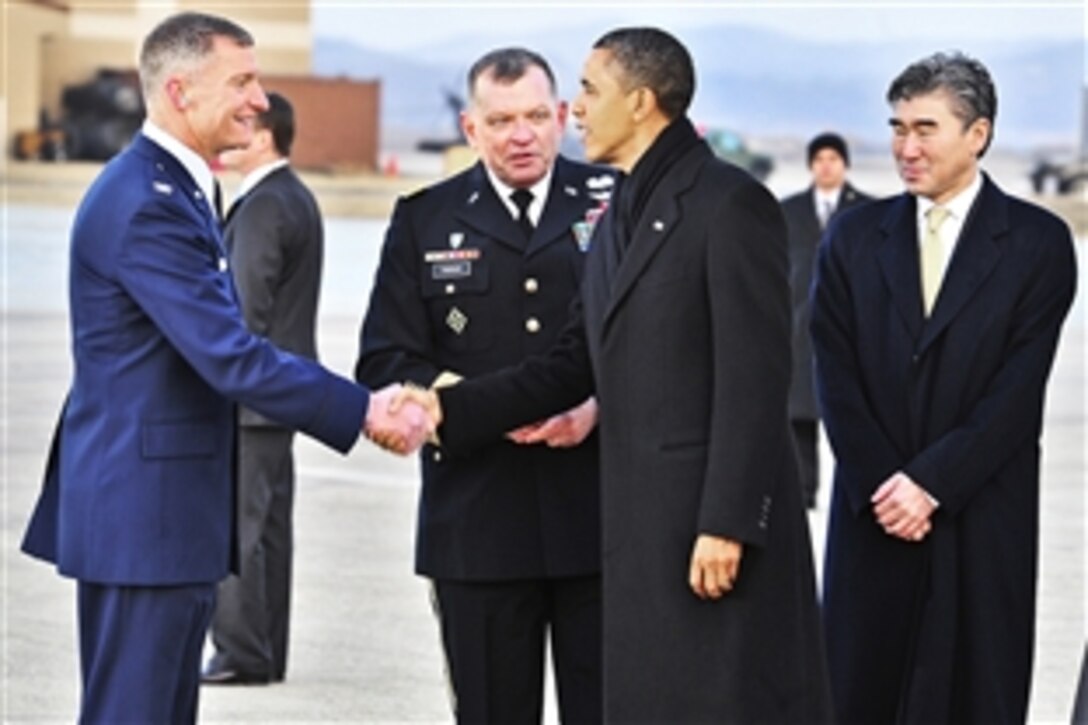 U.S. Air Force Col. Patrick McKenzie, left, shakes hands with President Barack Obama, during introduction by U.S. Army Gen. James Thurman on Osan Air Base, South Korea, March 25, 2012. Obama transited the base on his way to the 2012 Nuclear Security Summit in Seoul, South Korea. McKenzie is the commander, 51st Fighter Wing, Thurman is commander, United States Forces Korea.