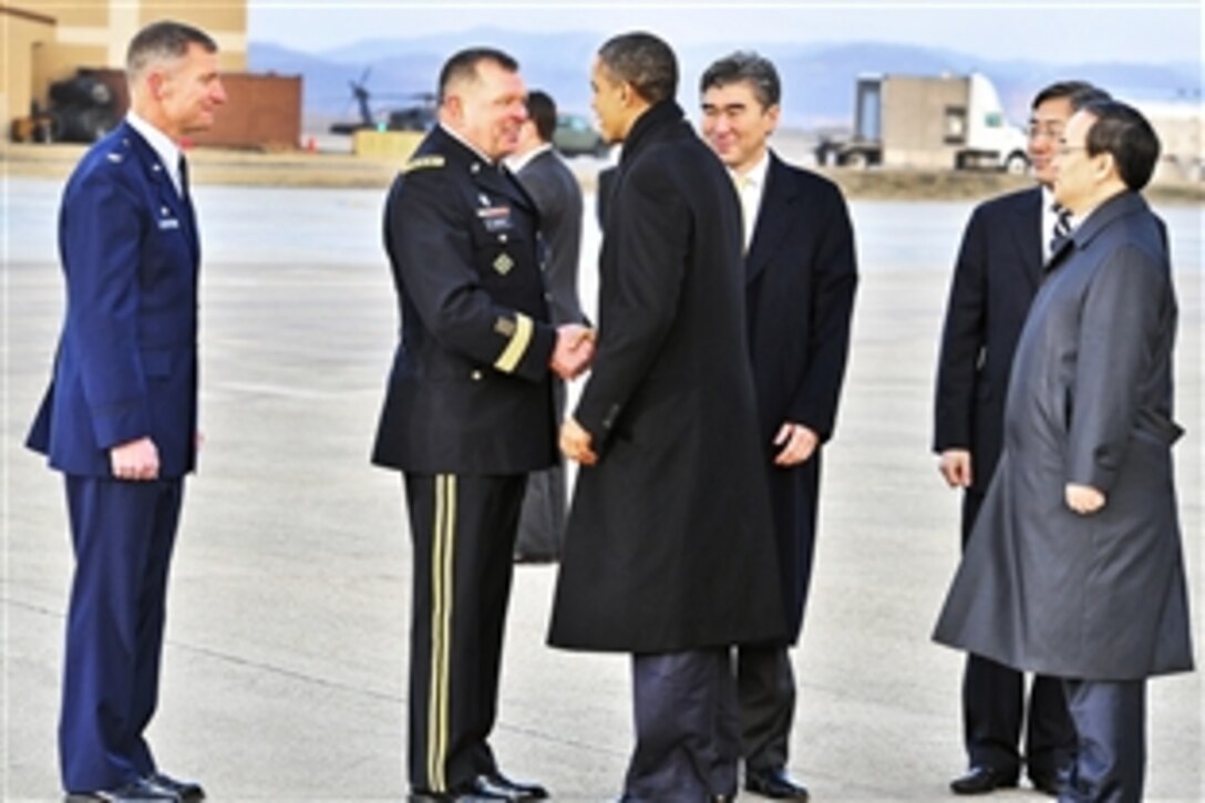 U.S. Army Gen. James Thurman, left, shakes hands with U.S. President Barack Obama upon his arrival on Osan Air Base, South Korea, March 25, 2012. Obama transited the base on his way to the 2012 Nuclear Security Summit in Seoul, South Korea. Thurman is commander, United States Forces Korea.