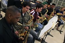 Gunnery Sgt. Jason Knuckles, 9th Marine Corps District Marine band placement director, and members of the Parris Island and San Diego Marine Corps bands perform with the Denfeld High School students while touring Northern Minnesota March 26. The Marine musicians also visited several high schools in Western Wisconsin. Their trip will conclude after performing at the Eau Claire Jazz Festival on March 30. For additional imagery involving their tour, visit www.facebook.com/rstwincities.
