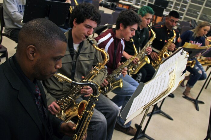 Gunnery Sgt. Jason Knuckles, 9th Marine Corps District Marine band placement director, and members of the Parris Island and San Diego Marine Corps bands perform with the Denfeld High School students while touring Northern Minnesota March 26. The Marine musicians also visited several high schools in Western Wisconsin. Their trip will conclude after performing at the Eau Claire Jazz Festival on March 30. For additional imagery involving their tour, visit www.facebook.com/rstwincities.