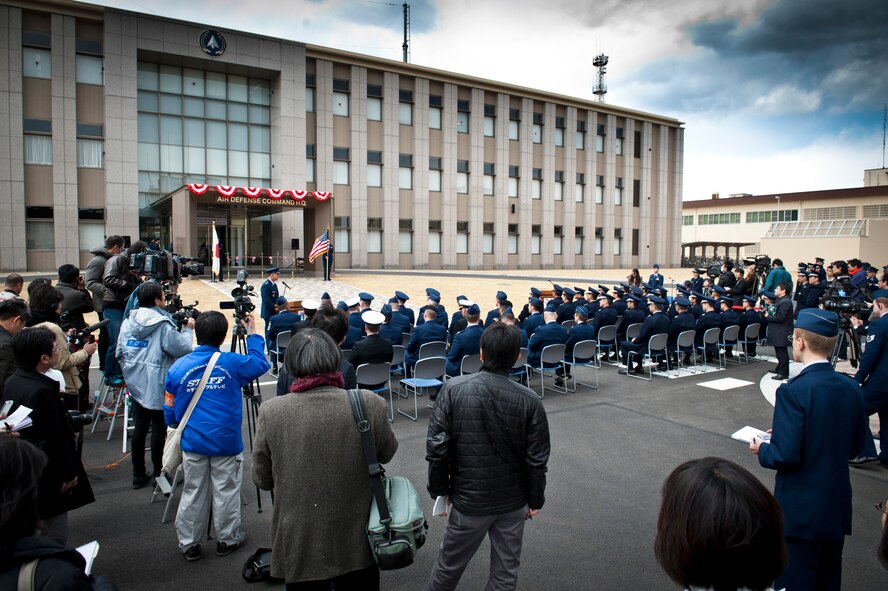 YOKOTA AIR BASE, Japan -- U.S. and Japanese officials hold an opening ceremony for the new Japan Air Self-Defense Force Air Defense Command Headquarters March 26, 2012. The ADC headquarters, which conducts command and control operations to defend Japanese airspace, was relocated from Fuchu Air Base, Japan, as part of the 2002 Defense Policy Review Initiative, a bilateral process to enhance the U.S.-Japan Security Alliance and address force realignments in the Pacific. (U.S. Air Force photo/Staff Sgt. Samuel Morse)