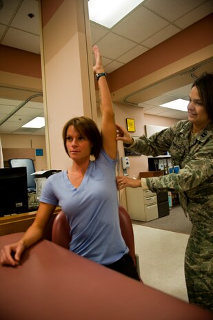 Capt. Leticia Venegas, 99th Medical Operations Squadron Physical Therapy element chief, measures the flexion of a patient's shoulder during a physical therapy session March 23, 2012 at Nellis Air Force Base, Nev. Physical therapy technicians see many different injuries and must work to rehabilitate patients from them.  (U.S. Air Force photo by Senior Airman Jack Sanders)