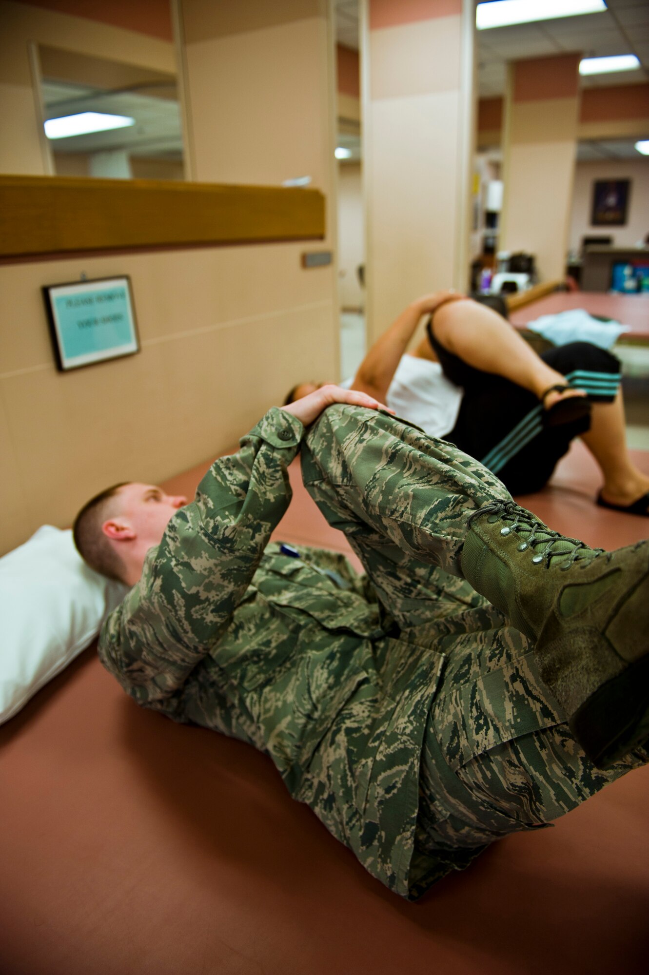 Senior Airman William Haus, 99th Medical Squadron Physical Therapy technician, demonstrates the proper technique of a stretch during a physical therapy session March 23, 2012 at Nellis Air Force Base, Nev. Physical Therapy technicians work to rehabilitate patients to ensure patients return to work quickly and safely. (U.S. Air Force photo by Senior Airman Jack Sanders)