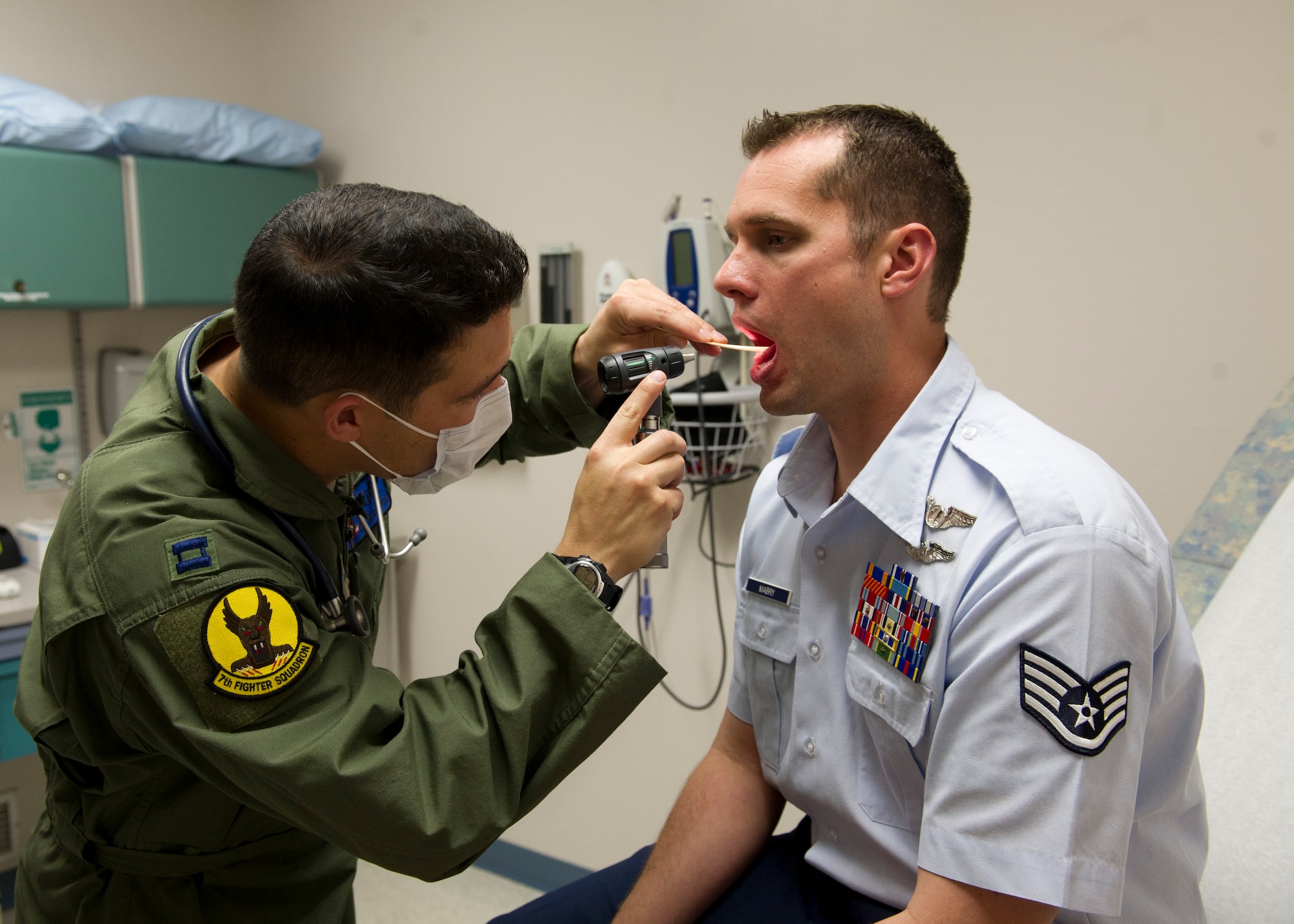 HOLLOMAN AIR FORCE BASE, N.M. – Capt. (Dr.) Oliver Edwards inspects the inside of Staff Sgt. Casey Mabry’s mouth during a medical examination March 26. Edwards is a 7th Fighter Squadron flight surgeon, and Mabry is part of the 16th Training Squadron. As a flight surgeon, Edwards is responsible for overseeing the health of any Airman on the base who’s on flying status. Flight surgeons also fly on a regular basis with the pilots in order to better understand what altitude or any other stressor might do to the body during flight. (U.S. Air Force photo by Airman 1st Class Siuta B. Ika/ Released)