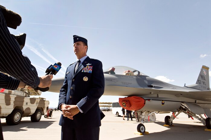 U.S. Air Force Brig. Gen. Charles L. Moore Jr., 57th Wing commander, speaks to the local news media moments after accepting command of the wing during a change of command ceremony March 26, 2012 at Nellis Air Force Base, Nev. Moore takes command of one of the most diverse wings in the Air Force, which  provides advanced aerospace training to world-wide combat air forces. (U.S. Air Force photo by Lawrence Crespo)