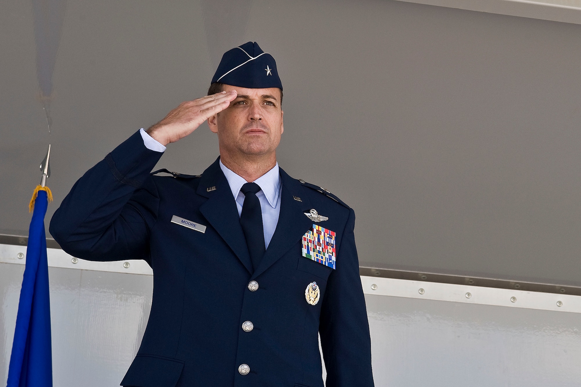U.S. Air Force Brig. Gen. Charles L. Moore Jr., 57th Wing commander, salutes his wing for the first time moments after accepting command March 26, 2012 at Nellis Air Force Base, Nev. Moore is responsible for four groups: the 57th Adversary Group, 57th Operations Group, 57th Maintenance Group and USAF Weapons School.  (U.S. Air Force photo by Airman 1st Class Matthew Lancaster)