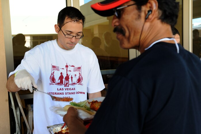 U.S. Air Force Staff Sgt. Joel Gurrero, 99th Medical Support Squadron information systems technician, serves lunch to local veterans during the 2012 Las Vegas Veterans Stand Down, March 21, 2012.  Hundreds of veterans attended the ninth annual Veterans Stand Down at the East Las Vegas Senior Community Center. The two-day event featured more than 100 community sponsors who offered assistance on health, housing, employment and legal advice. (U.S. Air Force photo by Staff Sgt. Taylor Worley)
