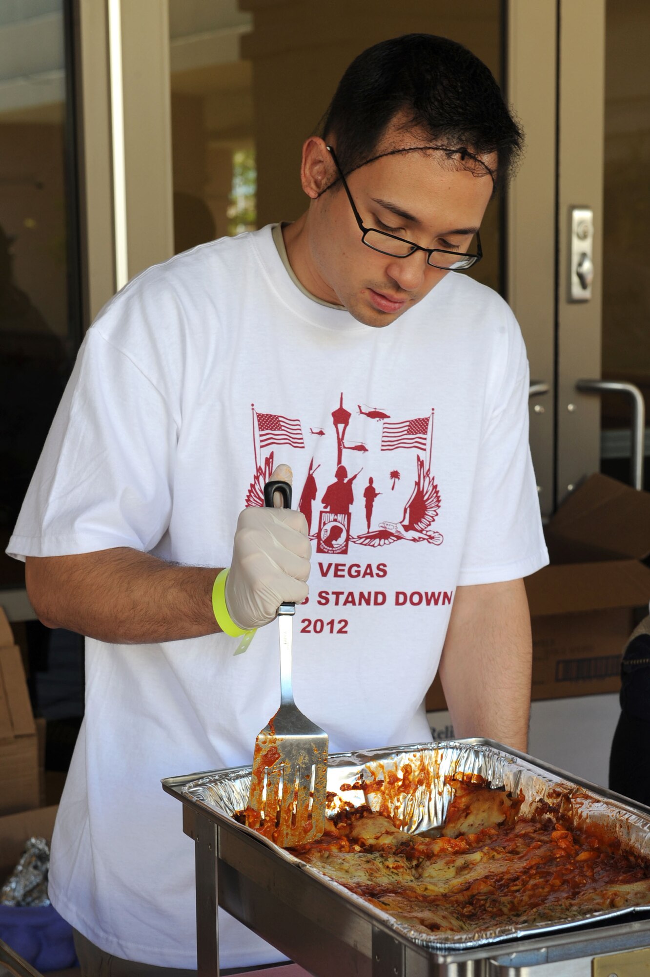 U.S. Air Force Staff Sgt. Joel Gurrero, 99th Medical Support Squadron information systems technician, serves lunch to local veterans during the 2012 Las Vegas Veterans Stand Down, March 21, 2012.   Veterans attending the ninth annual Veterans Stand Down at the East Las Vegas Senior Community Center were treated to three hot meals and snacks served by volunteers from the local community and Nellis Air Force Base. (U.S. Air Force photo by Staff Sgt. Taylor Worley)


