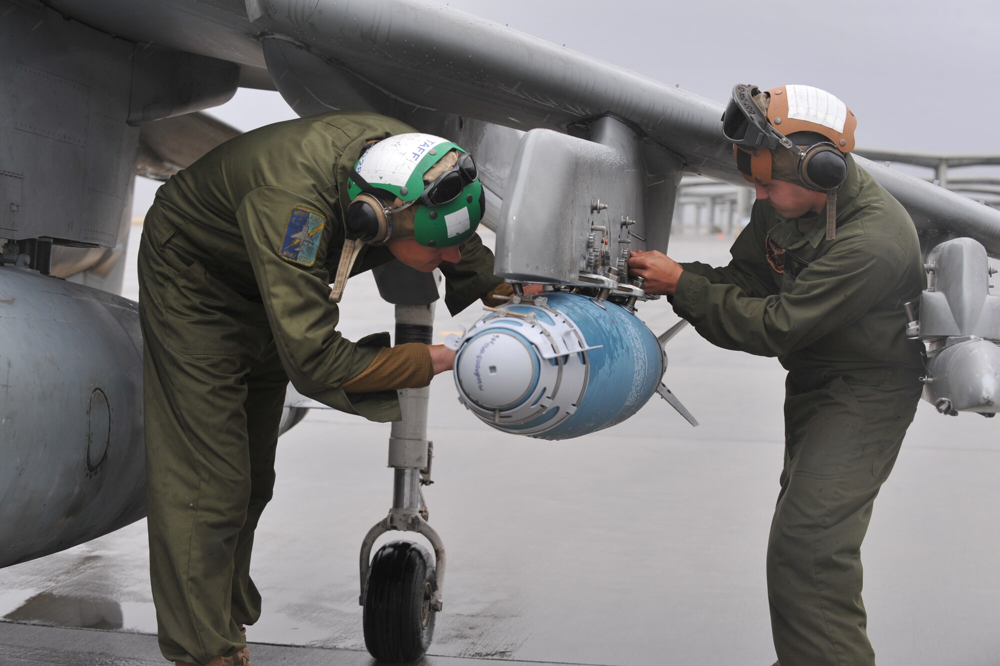U.S. Marine Corps Staff Sgt. Christopher Delvalle and Lance Cpl. Israel Martin inspect an AV-8B Harrier, March 16, 2012, at Mountain Home Air Force Base, Idaho. The AV-8B Harriers, also known as the “Flying Nightmares” are part of the U. S. Marine Corps attack squadron VMA-513. (U.S. Air Force photo/Airman 1st Class Heather Hayward)