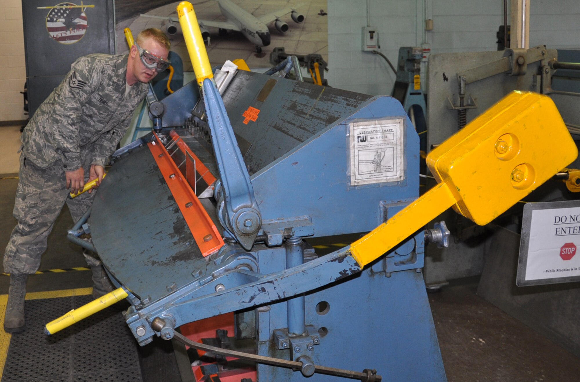 Staff Sgt. Andrew Tiehes, an aircraft structural maintainer with the 22nd MXS, uses a box-and-pan brake to bend a piece of sheet metal for a KC-135 Stratotanker part. (Air Force photo by Brannen Parrish).
