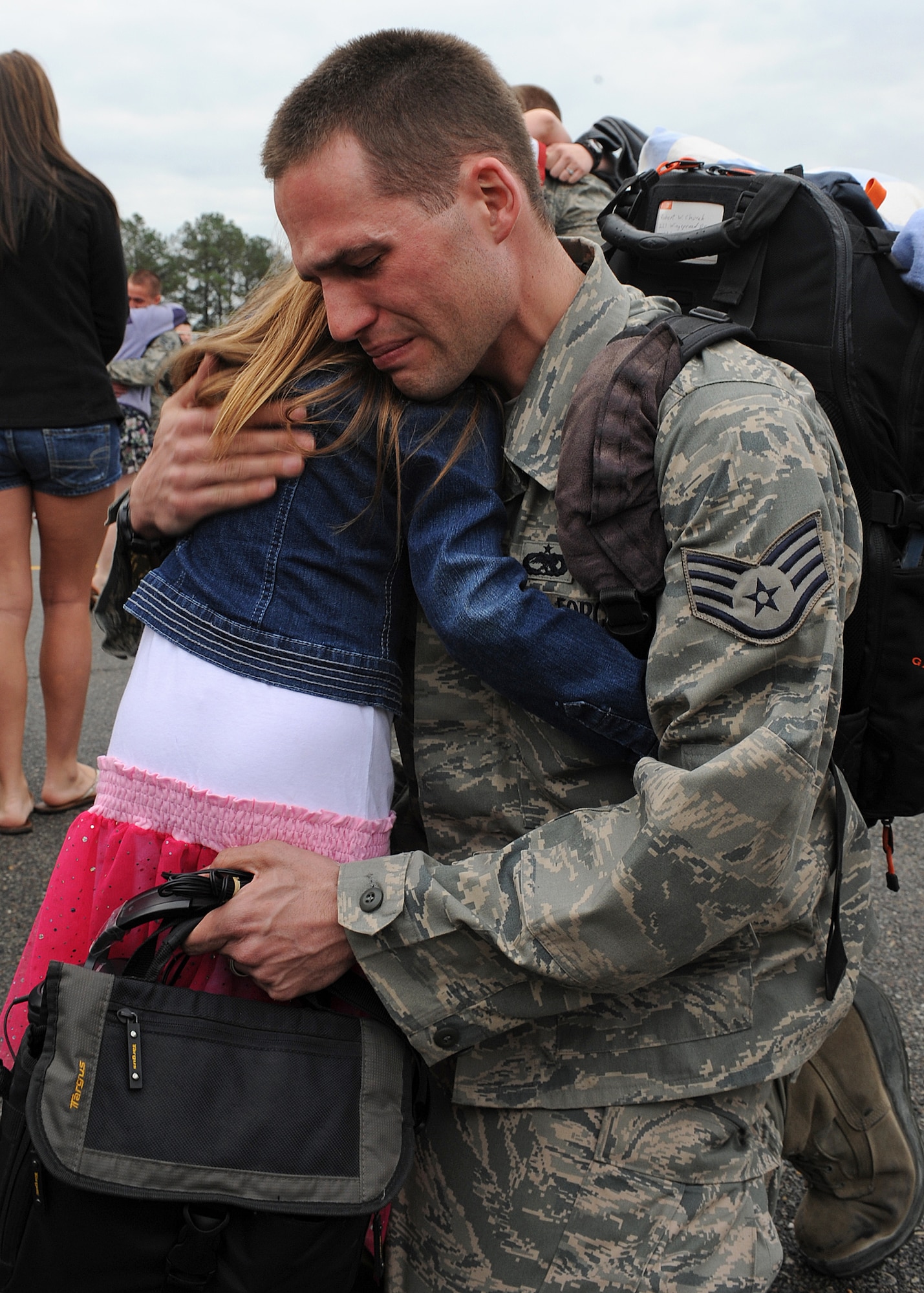 U.S. Air Force Staff Sgt. Robert Church hugs his daughter after returning from a deployment at Seymour Johnson Air Force Base, N.C., March 26, 2012. Church was one of nearly 300 Airmen returning home after a six-month deployment to Bagram Airfield, Afghanistan. Church is a member of the 335th Aircraft Maintenance Unit. (U.S. Air Force photo/Airman 1st Class John Nieves Camacho/Released)