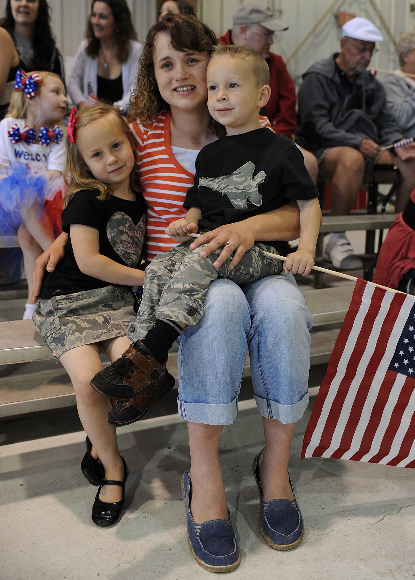 Jody Patterson awaits the arrival of her husband, U.S. Air Force Tech. Sgt. Nathan Patterson, with her children Bethany, left, and Levi in the fuels hangar at Seymour Johnson Air Force Base, N.C., March 26, 2012. Nathan was one of nearly 300 Airmen from the 4th Fighter Wing returning home from a six-month deployment to Bagram Airfield, Afghanistan. Nathan deployed from the 4th Aircraft Maintenance Squadron, and hails from Hackleburg, Ala. (U.S. Air Force photo/Airman 1st Class John Nieves Camacho/Released)