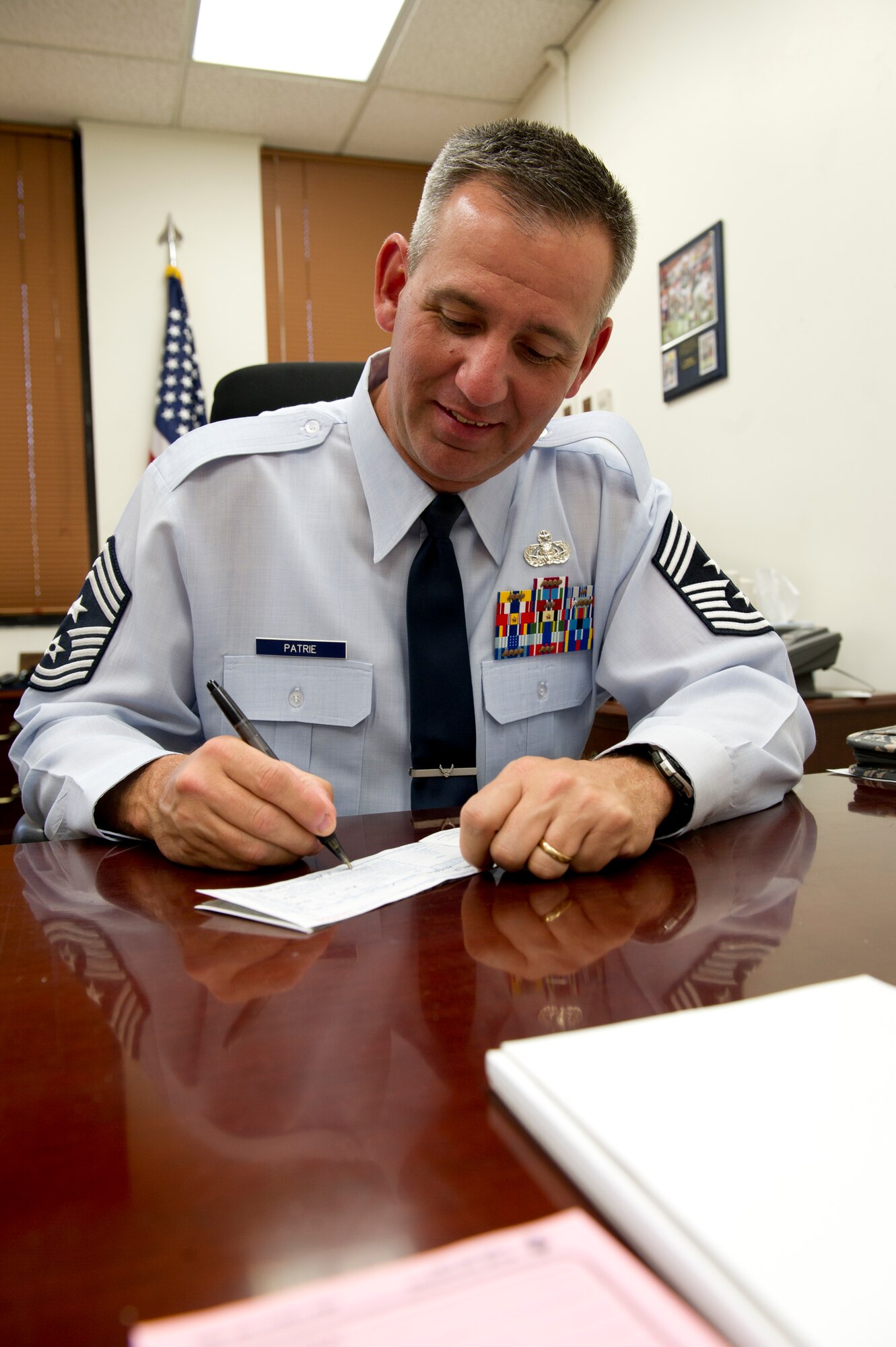 HOLLOMAN AIR FORCE BASE, N.M. – Command Chief Master Sgt. James Patrie, 49th Wing command chief, signs a pledge for the 2012 Air Force Assistance Fund campaign March 26. The AFAF was established to provide an annual effort to raise funds for the charitable affiliates that provide support to Air Force families in need. (U.S. Air Force photo by Senior Airman Kasey Close/Released)