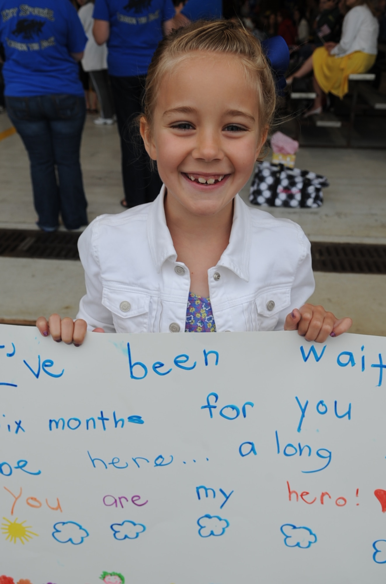 Macy Bowers smiles as she anticipates the arrival of her stepfather, U.S. Air Force Master Sgt. Nathan Bowers, on Seymour Johnson Air Force Base, N.C., March 26, 2012. Macy has not seen her father for six months due to his deployment to Bagram Airfield, Afghanistan. Bowers, 335th Aircraft Maintenance Unit, hails from Goldsboro, N.C. (U.S. Air Force photo/Airman 1st Class Aubrey Robinson/Released)