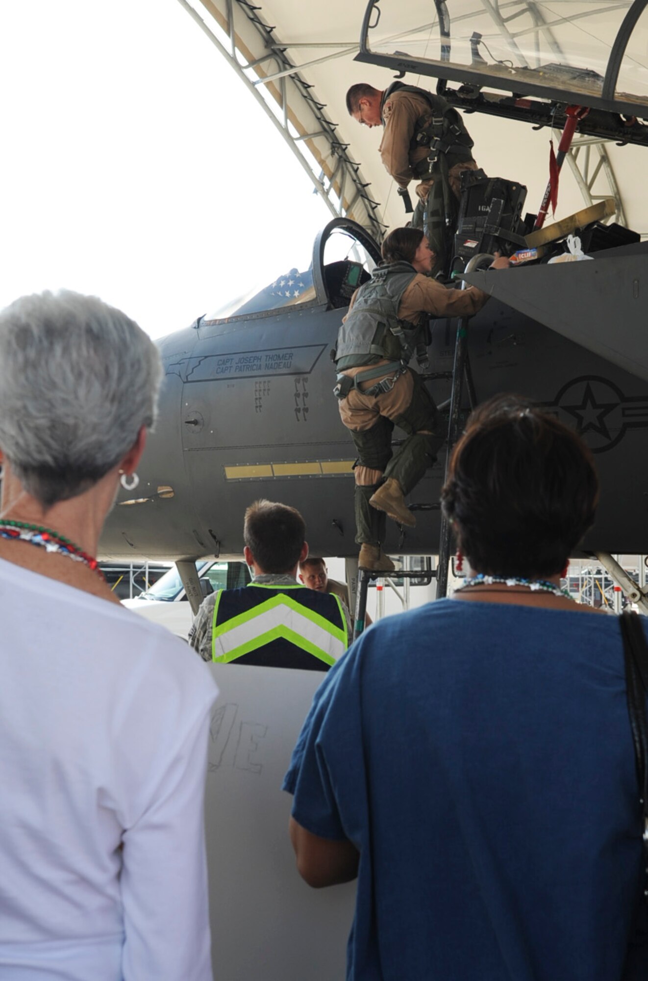 Sally Nadeau and Lori Laumann watch as U.S. Air Force Capt. Patricia Nadeau exits an F-15E Strike Eagle on Seymour Johnson Air Force Base, N.C., March 23, 2012. Nadeau is returning from a six-month deployment to Bagram Airfield, Afghanistan. Nadeau, 335th Fighter Squadron weapon systems officer, hails from Norfolk, Va. (U.S. Air Force photo/Airman 1st Class Aubrey Robinson/Released)