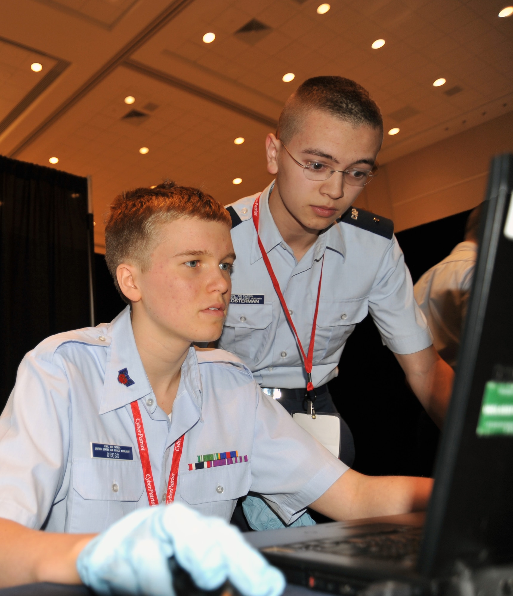 Civil Air Patrol Cadet Staff Sgt. Tyler Gross, left, and Cadet 2nd Lt. Daniel Klosterman try to crack a computer password during the digital forensics test at the CyberPatriot IV competition at the National Harbor, Md., March 23, 2012.  The cadets were tasked to find and examine evidence at a simulated cyber-crime scene, including frisking a suspect for electronic devices that contained possible clues of the password. Gross and Klosterman are with the Civil Air Patrol Big Sioux Squadron in Brookings, S.D. (U.S. Air Force photo/Airman 1st Class Alexander W. Riedel) 