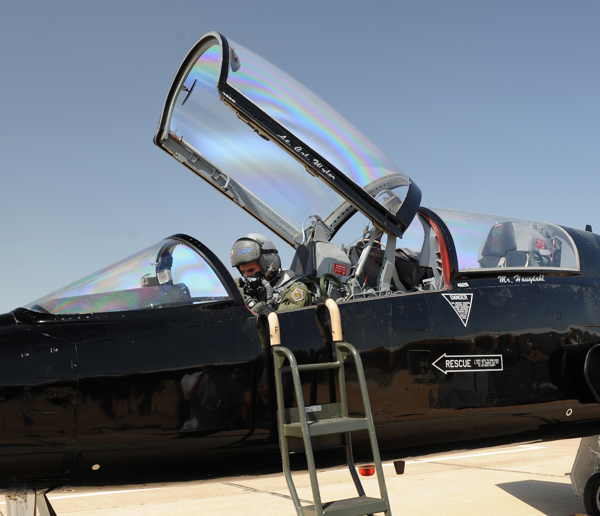 U.S. Air Force Col. Dave Lujan, Air Combat Command Inspector General chief of inspections, makes final adjustments before takeoff in a T-38 Talon on March 26, 2012 at Langley Air Force Base, Va. The T-38s are primarily used for joint, specialized, undergraduate-pilot training. (U.S. Air Force photo by Airman 1st Class Teresa Cleveland/Released)