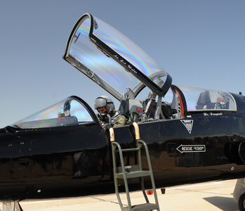 U.S. Air Force Col. Dave Lujan, Air Combat Command Inspector General chief of inspections, makes final adjustments before takeoff in a T-38 Talon on March 26, 2012 at Langley Air Force Base, Va. The T-38s are primarily used for joint, specialized, undergraduate-pilot training. (U.S. Air Force photo by Airman 1st Class Teresa Cleveland/Released)