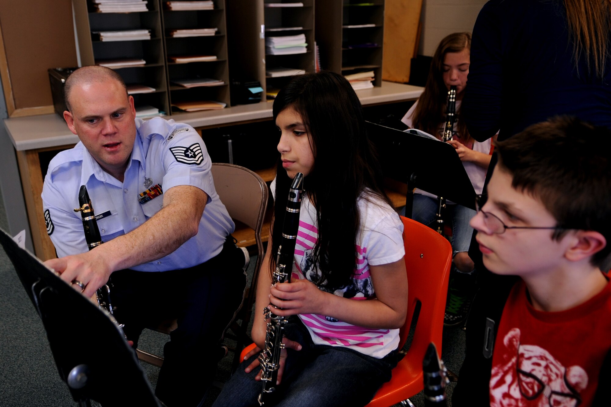 Tech. Sgt. Richard LaCroix, clarinetist with New Horizons, explains sheet music to students of Nathan Twining Middle School on Grand Forks Air Force Base, N.D., on March 15, 2012. Four members of New Horizons - part of the U.S. Air Force Heartland of America Band from Offutt AFB, Neb. - conducted 15 performances in five days for 1,107 children in on- and off-base schools earlier this month. (U.S. Air Force photo by Staff Sgt. Amanda N. Grabiec)