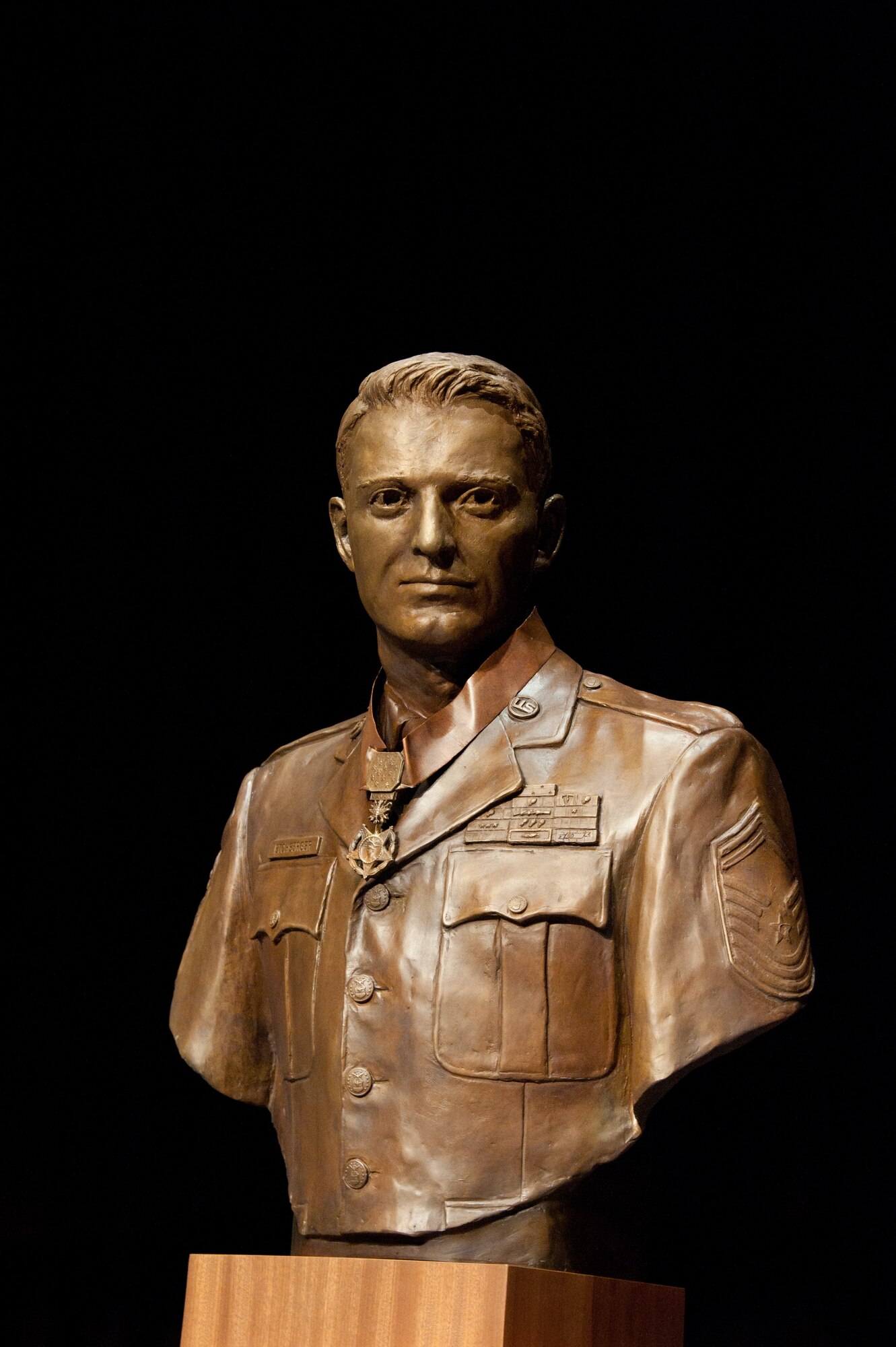 The bust of Medal of Honor recipient Chief Master Sergeant Richard L. Etchberger shines onstage at the Air Force Senior Noncommissioned Officer Academy on March 26, 2012.  The bust, sculpted by John Lajba, will be a part of the permanent exhibit at the academy.  (U.S. Air Force photo by Melanie Rodgers Cox)
