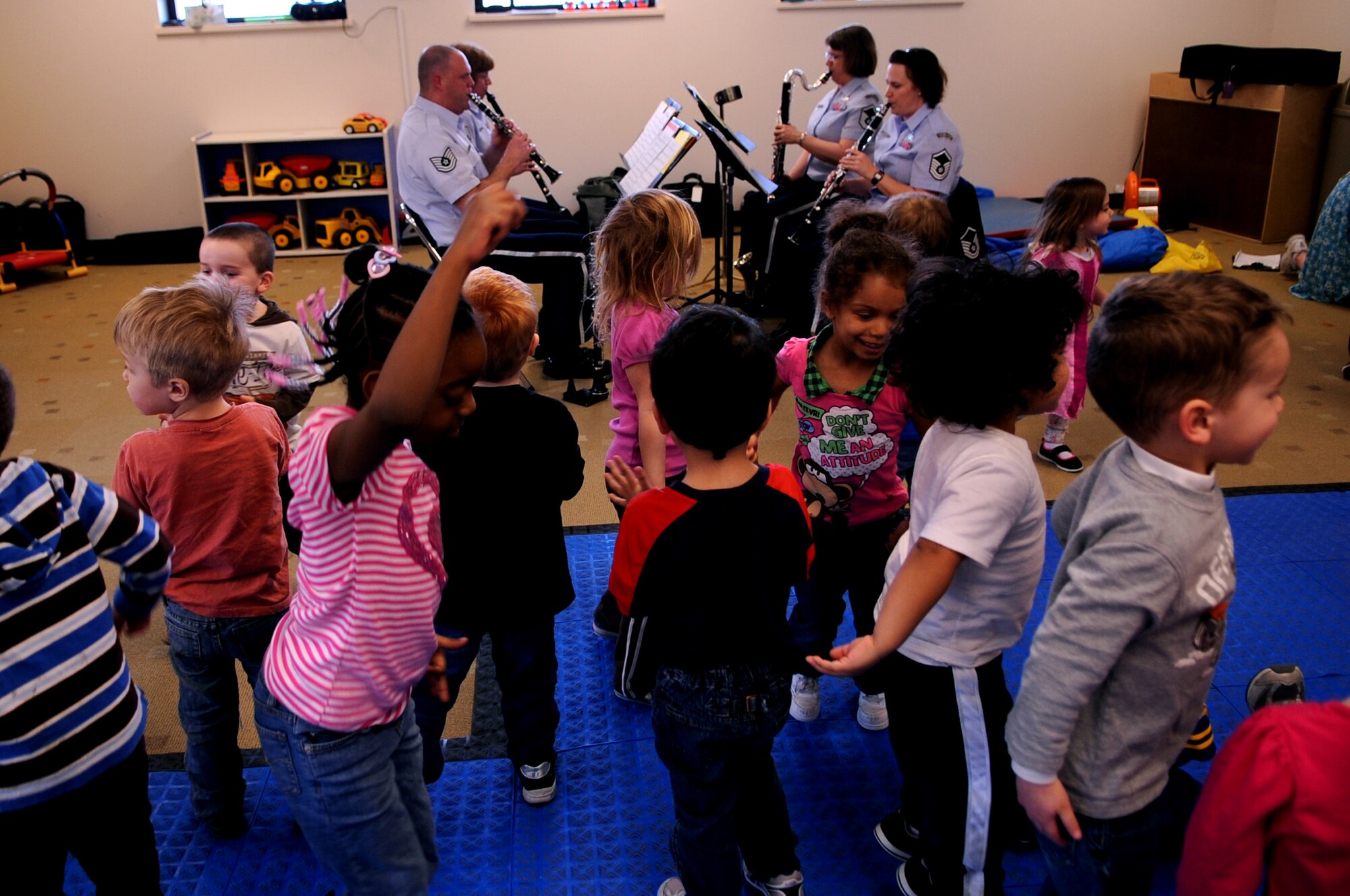 Children dance during the New Horizons performance at the Child Development Center on Grand Forks Air Force Base, N.D., on March 14, 2012. Four members of New Horizons - part of the U.S. Air Force Heartland of America Band from Offutt AFB, Neb. - conducted 15 performances in five days for 1,107 children in on- and off-base schools earlier this month. (U.S. Air Force photo by Staff Sgt. Amanda N. Grabiec)