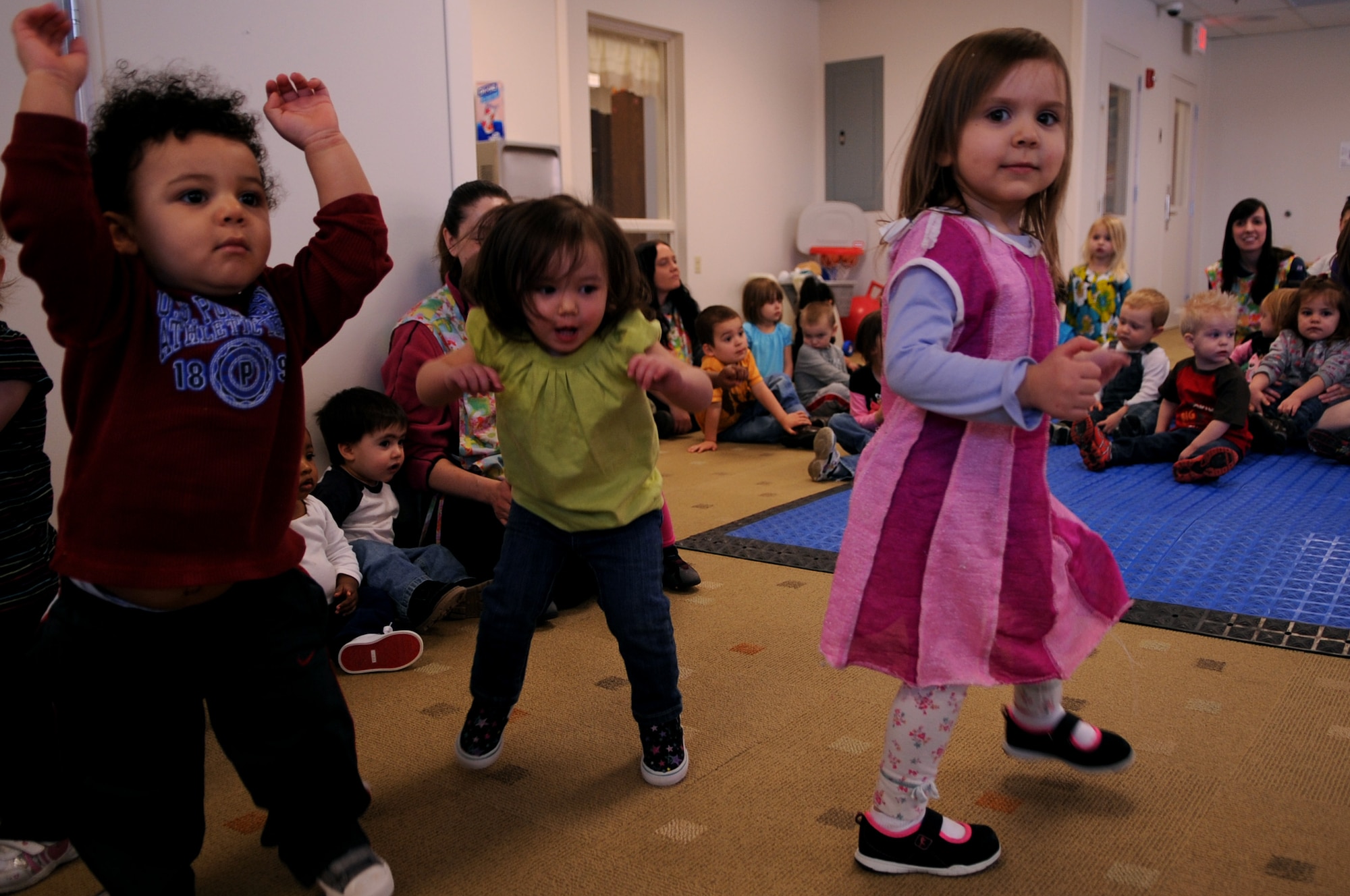 Children dance during the New Horizons quartet performance at the Child Development Center on Grand Forks Air Force Base, N.D., on March 14, 2012. Four members of New Horizons - part of the U.S. Air Force Heartland of America Band from Offutt AFB, Neb. - conducted 15 performances in five days for 1,107 children in on- and off-base schools earlier this month.  (U.S. Air Force photo by Staff Sgt. Amanda N. Grabiec)