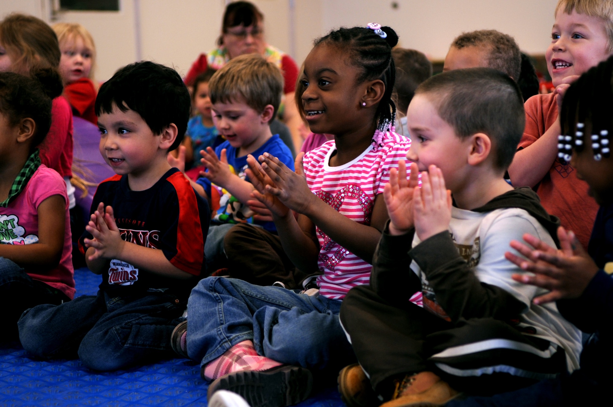 Children from the Child Development Center on Grand Forks Air Force Base, N.D., clap along with the music performed by the New Horizons quartet on March 14, 2012. Four members of New Horizons - part of the U.S. Air Force Heartland of America Band from Offutt AFB, Neb. - conducted 15 performances in five days for 1,107 children in on- and off-base schools earlier this month.  (U.S. Air Force photo by Staff Sgt. Amanda N. Grabiec)