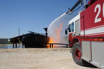 Members of the 902nd Civil Engineer Squadron fire department extinguish an aircraft fire during live fire training at the fire training area on Joint Base San Antonio-Randolph, Texas March 22. (U.S. Air Force photo by Rich McFadden) (released)