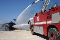Members of the 902nd Civil Engineer Squadron fire department hose down an aircraft fire at the Fire Training Area on Joint Base San Antonio-Randolph March 22. (U.S. Air Force photo by Rich McFadden) (released)