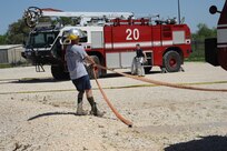 Airman First Class John Evans (left) and Senior Airman Ryan O'Grady, 902nd Civil Engineer Squadron fire department firefighters,  put away equipment after live fire training at the Fire Training Area on Joint Base San Antonio-Randolph March 22. (U.S. Air Force photo by Rich McFadden) (released)