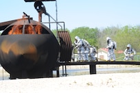 Members of the 902nd Civil Engineer Squadron fire department prepare to enter a burning aircraft during live fire training at the fire training area on Joint Base San Antonio-Randolph March 22. (U.S. Air Force photo by Rich McFadden) (released)
