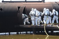 Members of the 902nd Civil Engineer Squadron fire department practice entering a burning aircraft at the Fire Training Area on Joint Base San Antonio-Randolph March 22. (U.S. Air Force photo by Rich McFadden) (released)