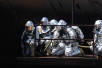Members of the 902nd Civil Engineer Squadron fire departmentgather before entering a burning aircraft at the Fire Training Area on Joint Base San Antonio-Randolph March 22. (U.S. Air Force photo by Rich McFadden) (released)