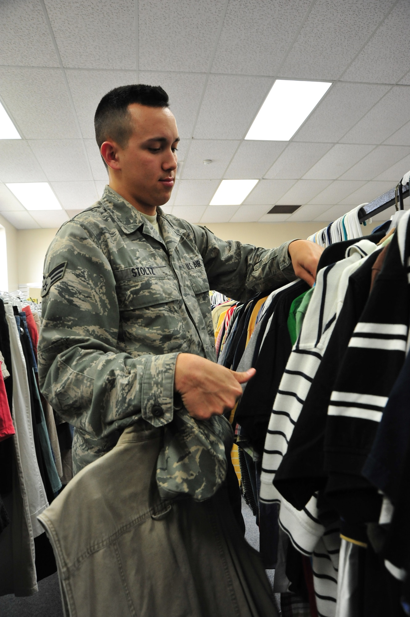 Senior Airman Christopher Stoltz looks through some of the donated items at Maxwell Air Force Base's Airman's Attic, March 20. Maxwell’s Airman’s Attic provides a variety of items to enlisted Airmen E-6 and below. (U.S. Air Force photo by Airman 1st Class William Blankenship) 
