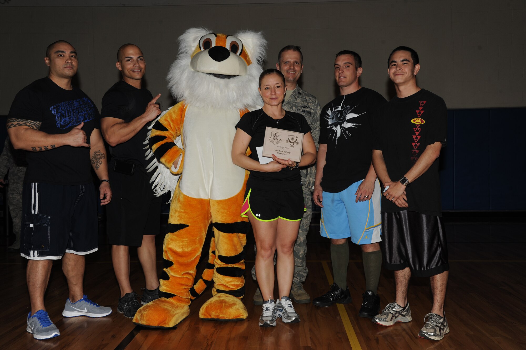 Members of the 23d Force Support Squadron pose with the 23d Wing mascot as they win the Top 3 push-up challenge at Moody Air Force Base, Ga., March 21, 2012. The 23d FSS team won the competition with a total of 1,103 push-ups in 10 minutes and beat out their competitors by approximately 100 push-ups. (U.S. Air Force photo by Airman 1st Class Paul Francis/Released)
