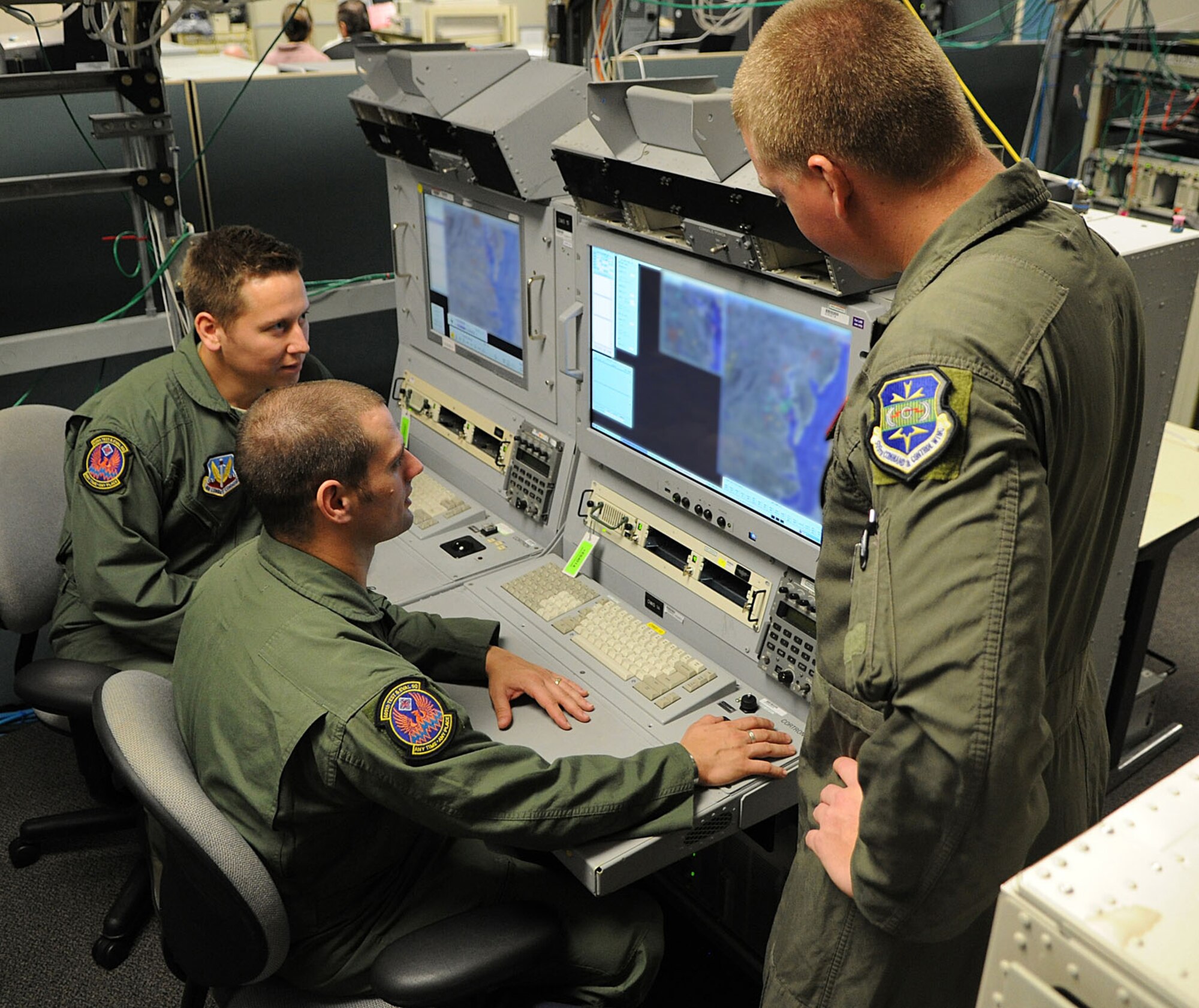 MELBOURNE, Fla. - Members of the 605th Test and Evaluation Squadron, Detachment 2, try out new 27-inch display Joint STARS operator workstations in the Northrop Grumman-Melbourne integration lab. The Electronic Systems Center is working to upgrade critical mission equipment, such as the workstations and the operating system, on the Joint STARS platform. (Courtesy photo) 