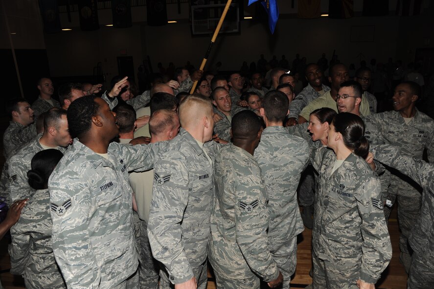 Students from the Senior Airman Jason D. Cunningham Airman Leadership School huddle around after two teams representing ALS completed the 10 minute push-up challenge at Moody Air Force Base, Ga., March 21, 2012. Both teams were cheered on by their fellow Airmen as they racked up totals of 946 and 913 push-ups.  (U.S. Air Force photo by Airman 1st Class Paul Francis/Released)
