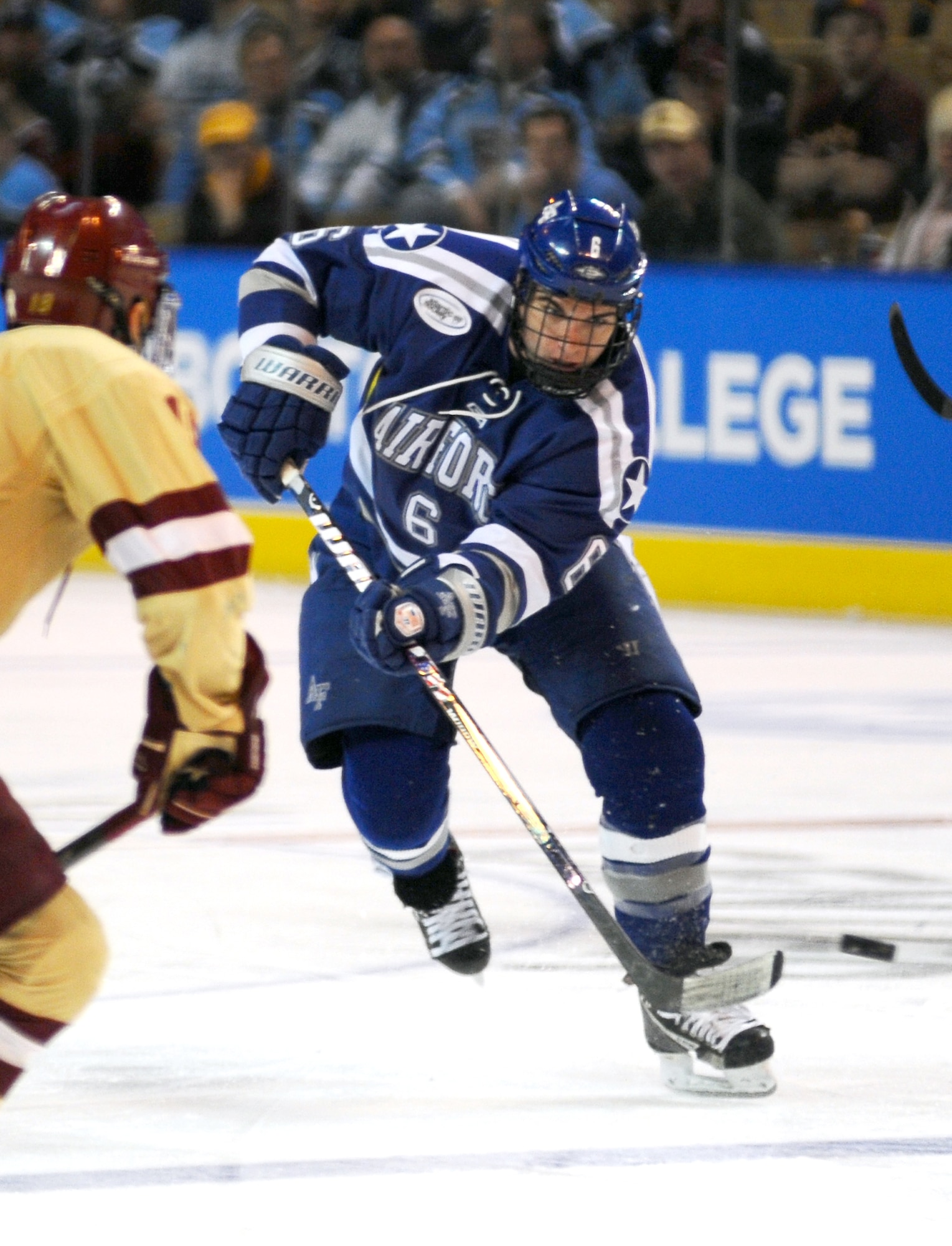 Air Force Academy Falcons’ defenseman Adam McKenzie pushes the puck up the ice during the NCAA Hockey Championship Tournament in Worcester, Mass., March 24, 2012. The Falcons came up short against the Boston College Eagles 2-0. (U.S. Air Force photo/Tech. Sgt. Raymond Hoy)