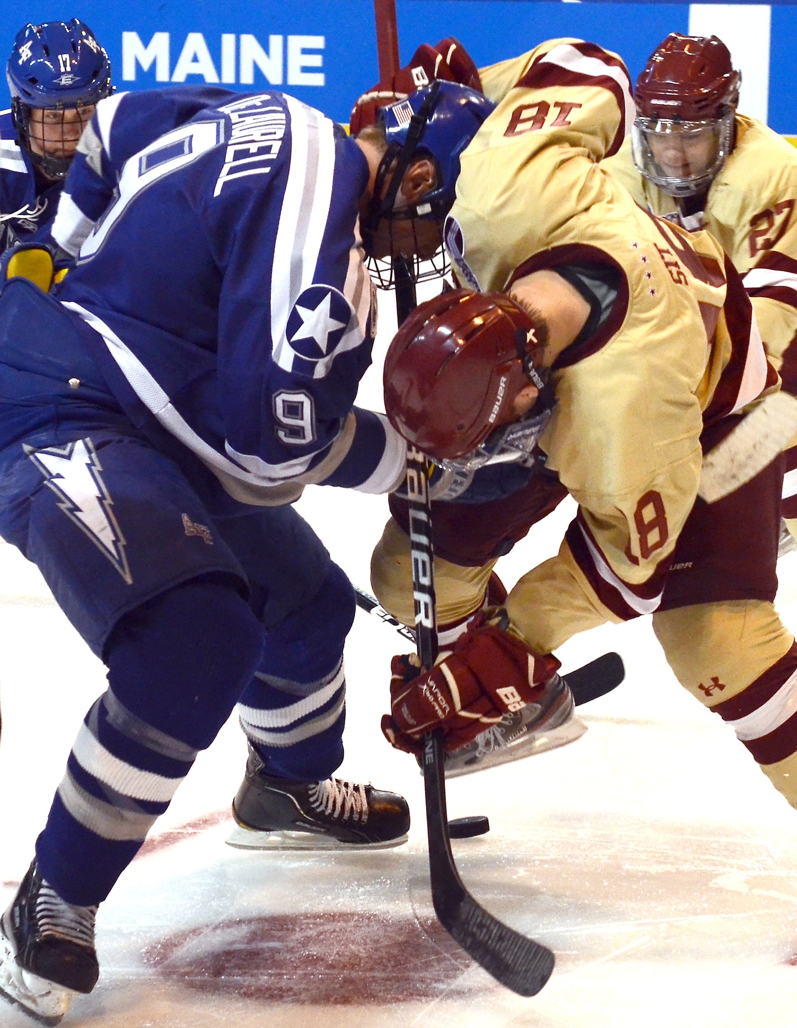 Kyle DeLaurell, left, and Michael Sit face off during the NCAA Hockey Championship Tournament in Worcester, Mass., March 24, 2012. This was the Air Force Academy Falcons' fifth trip to the tournament in the last six years. DeLaurell is with the Falcons and Sit is with the Boston College Eagles. (U.S. Air Force photo/Tech. Sgt. Raymond Hoy)